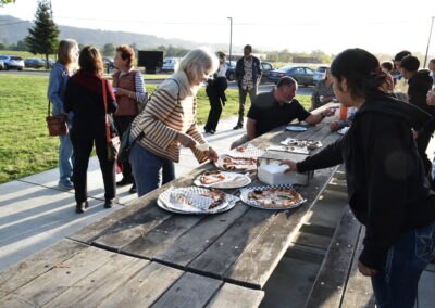 Attendees enjoying pizza